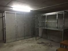 an empty room with several cages in it