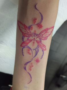 a woman's arm with a tattoo design on the left side of her arm