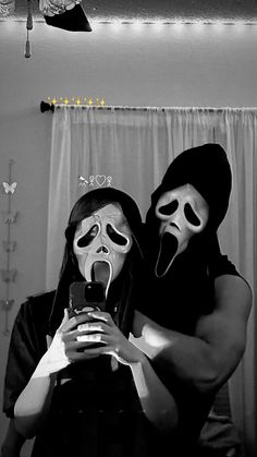 two people with masks on taking a selfie