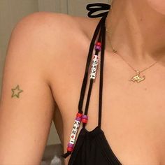 a woman with tattoos on her chest wearing a lanyard