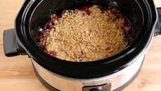 the crock pot is full of oatmeal and berries, ready to be cooked