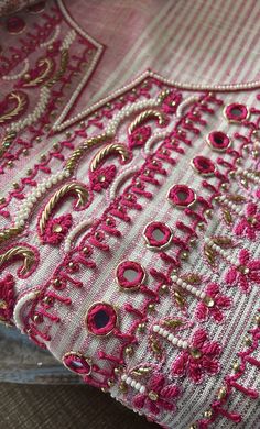 closeup of pink and gold embroidered material