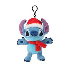 a stuffed animal with a red hat and scarf on it's head is hanging from a keychain