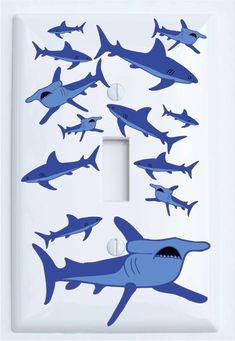 a light switch cover with blue sharks on it