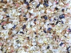 a large pile of colorful confetti sitting on top of a table