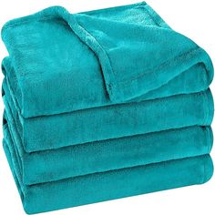 a stack of teal towels folded on top of each other