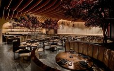 an empty restaurant with wooden tables and chairs