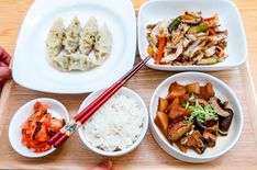 a tray with different types of food and chopsticks