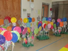 there are many colorful balloons in the room