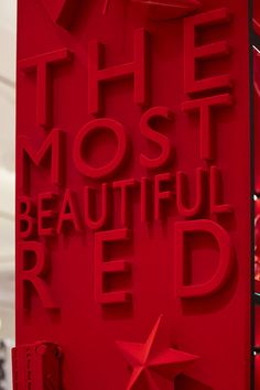 the most beautiful red sign is displayed in front of a storefront window, and it says'the most beautiful red '