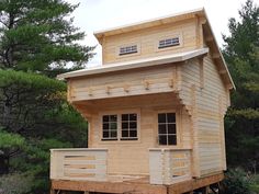 a small wooden house sitting in the woods