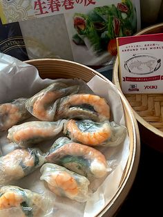 some shrimp and rice dumplings are in a basket next to a packet of noodles