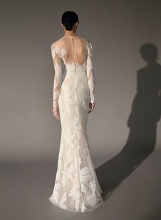 the back of a woman's wedding dress with long sleeves