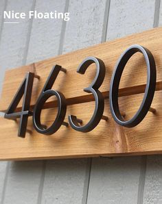 a house number sign mounted to the side of a building