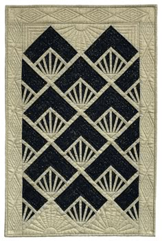 a black and white quilted wall hanging