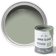 an open can of annie sloan chalk paint next to a tin of the same color