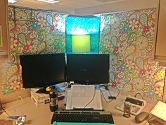 two computer monitors sitting on top of a desk next to a keyboard and monitor screen