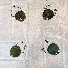 four different types of bugs on a white cloth with holes in the middle and eyes