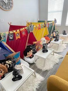 a room filled with lots of stuffed animals on tables next to tents and chairs in front of them