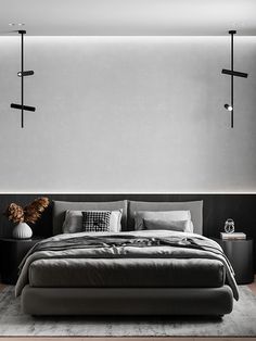 a large bed sitting in the middle of a bedroom next to a wall mounted light