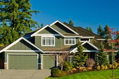 a large house with lots of trees in the front yard