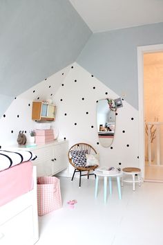 a room with white walls and polka dots on the wall