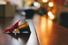 a small red bird sitting on top of a wooden table next to a party horn