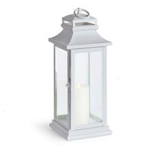 a white lantern with a lit candle on the front and side, against a white background