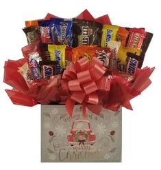 a gift bag filled with assorted candy and candies, wrapped in red ribbon