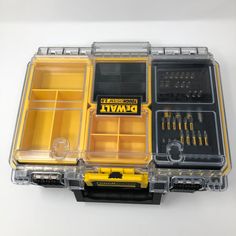 an open tool box with tools in it on a white surface, including screwdrives and pliers