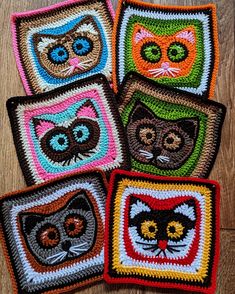 crocheted coasters with cats on them sitting on a wooden floor in the shape of squares