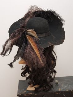 an old hat with feathers on top of it