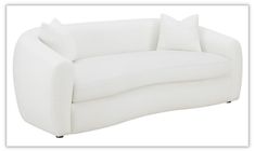 a white couch with two pillows on the back and one pillow on the armrest