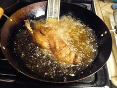 chicken being cooked in a frying pan on the stove