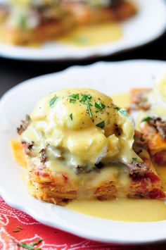 two white plates topped with lasagna casserole covered in cheese