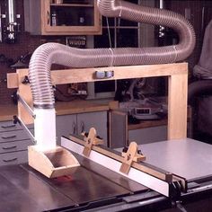 a machine that is sitting in the middle of a kitchen counter with pipes coming out of it