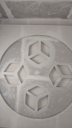 the ceiling is covered in white paint and has four hexagonal shapes on it