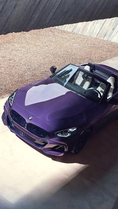 a purple sports car is parked in the driveway