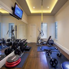 an exercise room with treadmills, machines and television on the wall that says back at it january mood