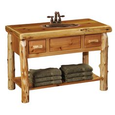 a wooden sink table with two drawers and towels on it's shelf, against a white background