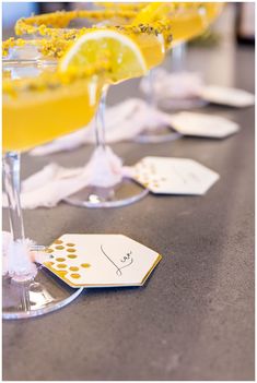 three glasses filled with different types of drinks on top of a table next to each other