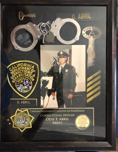 a police officer's shadow and badge is on display in a glass framed case