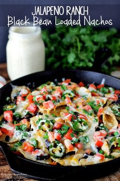 black bean loaded nachos in a cast iron skillet