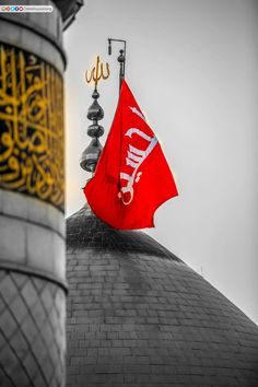 a red flag on top of a building