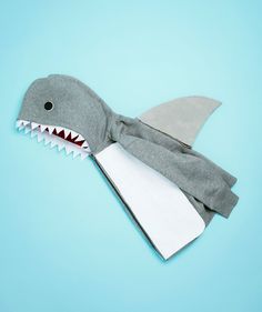 a stuffed shark toy on a blue background