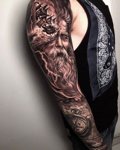 a man with a full sleeve tattoo on his arm