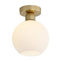 a light fixture with a white glass ball on the top and a gold plated finish