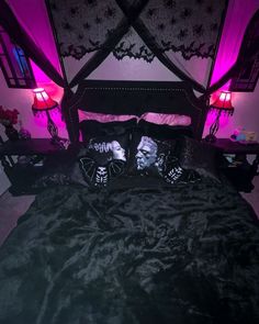 a bed with purple lights and pillows on it