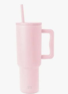 a pink coffee cup with a straw sticking out of it's side, against a white background