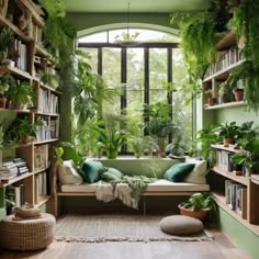 a room filled with lots of green plants and bookshelves next to a window